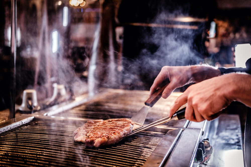 master-chef-wearing-uniform-cooking-delicious-beef-steak-kitchen-restaurant